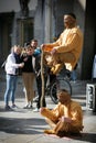 People on the Cologne street looking at the magic indian artists in orange clothes