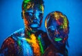 People are colored fluorescent powder. a pair of lovers dancing at a disco. Royalty Free Stock Photo