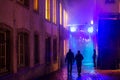 People on colorful illuminated street