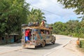 People in colorful traditional bus jeepney in Palawan