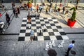 People come and go around four giant chess sets in the Quartier des spectacles in Montreal