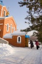 People come out of the cathedral with blessed water