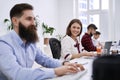 People communicating and working in modern IT office. Group of young and experienced programmers and software developers Royalty Free Stock Photo