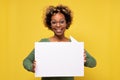 Happy african american young woman holding blank speech bubble Royalty Free Stock Photo