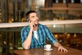 Man with coffee calling smartphone at restaurant Royalty Free Stock Photo