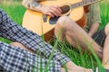 People company in nature with acoustic guitar incognito person without face in summer time bright clear weather day green grass Royalty Free Stock Photo