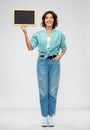 Portrait of smiling woman showing black chalkboard Royalty Free Stock Photo