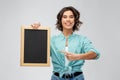 Portrait of smiling woman showing black chalkboard Royalty Free Stock Photo