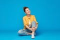 Red haired teenage girl in shirt and torn jeans Royalty Free Stock Photo