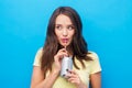 Young woman or teenage girl drinking soda from can