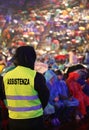 People during a concert and a boy with jacket with text ASSISTEN