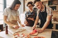 People cooking together. Company of friends chopping ingredients