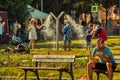 People cools down sun in public mist machine at Park