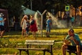 People cools down sun in public mist machine at Park