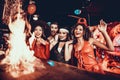 People in Costumes Looking at Flaming Cocktail Royalty Free Stock Photo