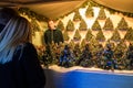 People at counter with Christmas trees in Christmas market at Cathedral Square Vilnius at night