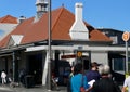 People cross King Street to get to Newtown Railway Station