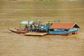 People cross Mekong river by local ferry in Luang Prabang, Laos.