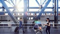 People cross the railway bridge on a sunny morning when a passenger train passes by. 3D Rendering.