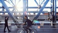 People cross the railway bridge on a sunny morning when a passenger train passes by. 3D Rendering.