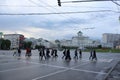 People cross the road at a pedestrian crossing on Borovitskaya Square