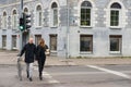 People cross the road at the traffic light in Vilnius, Lithuania.