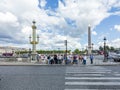 People cross the street at a traffic light for pedestrians at place de la concorde in the heart of Paris.at Champs dÃÂ´ Elysees Royalty Free Stock Photo