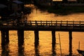 People Cross The Wood Bridge in Sunset, Nyaungshwe, Myanmar Royalty Free Stock Photo