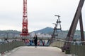 people crossing the bridge over the NerviÃ³n river next to the Guggenheim Museum in Bilbao-Basque country-Spain Royalty Free Stock Photo