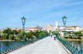 people crossing the bridge over the Tua river in the village of Mirandela, Portugal Royalty Free Stock Photo