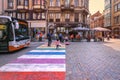 people crossing colorful pedestrian zebra in the old city center of Brussels