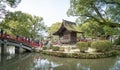 People are crossing the famous red bridge of Dazaifu shrine.