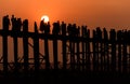 People crossing the longest teak bridge in the world, the iconic wooden U Bein Bridge during sunset, Mandalay, Myanmar Royalty Free Stock Photo