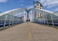 People crossing the Millennium bridge, Salford Quays, Manchester, England. Royalty Free Stock Photo