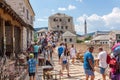 People crossing the Old Bridge Stari Most during the summer. Mostar, Bosnia and Herzegovina. Royalty Free Stock Photo