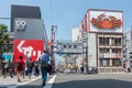 People crossing the pedestrian walkway towards the start of Dotonbori Street,  a popular shopping and dining arcade at Osaka Royalty Free Stock Photo