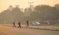 People crossing the road amidst heavy smog in Delhi