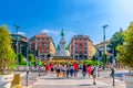 People crossing road street near Monument Giuseppe Garibaldi statue on Largo Cairoli square in Milan