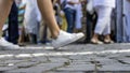 People crossing street, close up of feet. Tram rails Royalty Free Stock Photo