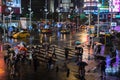 People crossing street in front of Ximending Shopping District with falling rain at night in Taipei, Taiwan. Ximending is the
