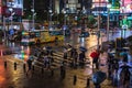 People crossing street in front of Ximending Shopping District with falling rain at night in Taipei, Taiwan. Ximending is the