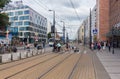 People crossing the tram tracks at Pawia Street, Krakow, Poland