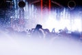 People crowd on a dance floor during a concert with a light show Royalty Free Stock Photo