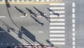 People crowd walk in top view at street city with pedestrian crosswalk in traffic road with light and shadow silhouette Royalty Free Stock Photo