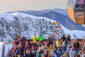 People crowding on observation platform by 2200 m ski lift station of Gorky Gorod mountain ski resort watching winter sunset