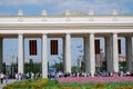 People crowds enter and leave Gorky park by the main entrance gates.
