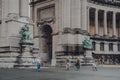 People cycle past the base of Triumphal Arch in Parc du Cinquantenaire, Brussels, Belgium Royalty Free Stock Photo