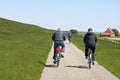 People cycling along the Dutch seawall of North Sea