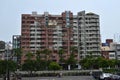 People cycling in front of an old apartment