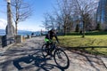 People cycling in Harbour Green Park, on the Vancouver Harbour shore.